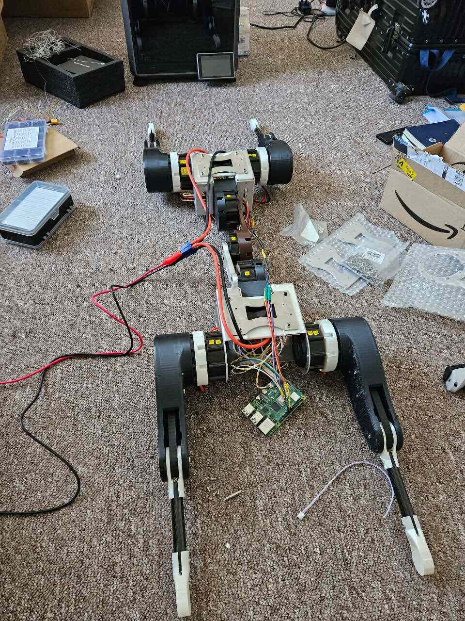 The first prototype in 2023, on the carpet with a Raspberry Pi strapped to it